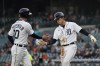 Detroit Tigers' Kerry Carpenter (30) greets Nick Maton after they both scored on a single by Eric Haase during the third inning of a baseball game against the Baltimore Orioles, Thursday, April 27, 2023, in Detroit. (AP Photo/Carlos Osorio)