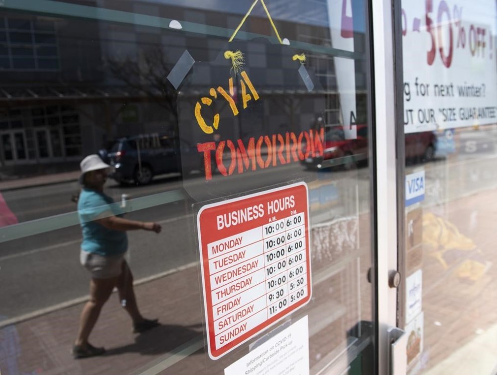 A sign on a small business welcomes shoppers to return the next day, in Ottawa, on Monday, May 18, 2020. Almost a third of Canadian small business owners raised prices in 2022 by more than 10 per cent to offset rising costs, a survey found. THE CANADIAN PRESS/Justin Tang