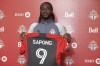 Newly acquired Toronto FC forward C.J. Sapong shows off his jersey Friday, April 28, 2023, at the MLS club‘s training facility, in Toronto. THE CANADIAN PRESS/Neil Davidson