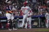 Philadelphia Phillies' Edmundo Sosa, right, scores as Houston Astros catcher Martin Maldonado stands in front of home plate during the seventh inning of a baseball game Friday, April 28, 2023, in Houston. (AP Photo/David J. Phillip)
