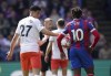 Crystal Palace's Eberechi Eze, right, reacts with West Ham United's Nayef Aguerd, after he was fouled in the penalty area, during the English Premier League soccer match between Crystal Palace and West Ham United at Selhurst Park, in London, Saturday April 29, 2023. (John Walton/PA via AP)
