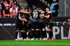 Freiburg's players celebrate their side's opening goal during the German Bundesliga soccer match between 1. FC Cologne and SC Freiburg in Cologne, Germany, Saturday, April 29, 2023. (Federico Gambarini/dpa via AP)