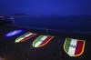 The logo of Napoli soccer team, right, and three 'scudetto', referring to the two Serie A titles won in 1987, 1990 and the likely 2023, are projected on the Posillipo beach in Naples, Italy, Thursday, April 27, 2023. Napoli could get the chance to clinch its first Serie A title since Diego Maradona’s playing days in front of its fans this weekend at the stadium now named after the club’s most emblematic player. (Alessandro Garofalo/LaPresse via AP)