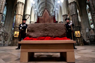 King's Bodyguards for Scotland and members of Royal Company of Archers Alex Baillie-Hamilton, left, and Paul Harkness stand guard by the Stone of Destiny, during a welcome ceremony in Westminster Abbey, London, Saturday, April 29, 2023. (Susannah Ireland/Pool Photo via AP)