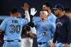 Toronto Blue Jays' Daulton Varsho (centre) celebrates his game-winning walk-off single against the Seattle Mariners in tenth inning American League baseball action in Toronto on Saturday, April 29, 2023. THE CANADIAN PRESS/Jon Blacker