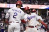 Texas Rangers' Ezequiel Duran is congratulated by Marcus Semien (2) after hitting a two-run home run against the New York Yankees during the fifth inning of a baseball game Saturday, April 29, 2023, in Arlington, Texas. (AP Photo/Sam Hodde)