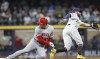 Los Angeles Angels' Shohei Ohtani, left, steals second base as Milwaukee Brewers' Owen Miller takes a late throw in the eighth inning of a baseball game Saturday, April 29, 2023, in Milwaukee. (AP Photo/Jeffrey Phelps)