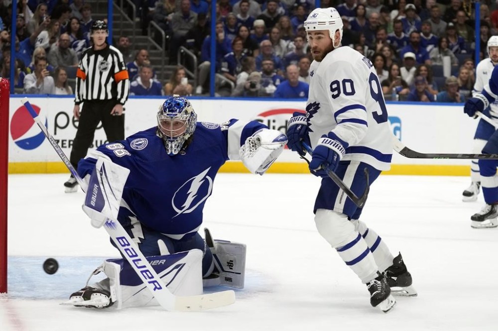 Toronto Maple Leafs center Ryan O'Reilly (90) chases a rebound after Tampa Bay Lightning goaltender Andrei Vasilevskiy (88) made a save during the first period in Game 6 of an NHL hockey Stanley Cup first-round playoff series Saturday, April 29, 2023, in Tampa, Fla. (AP Photo/Chris O'Meara)