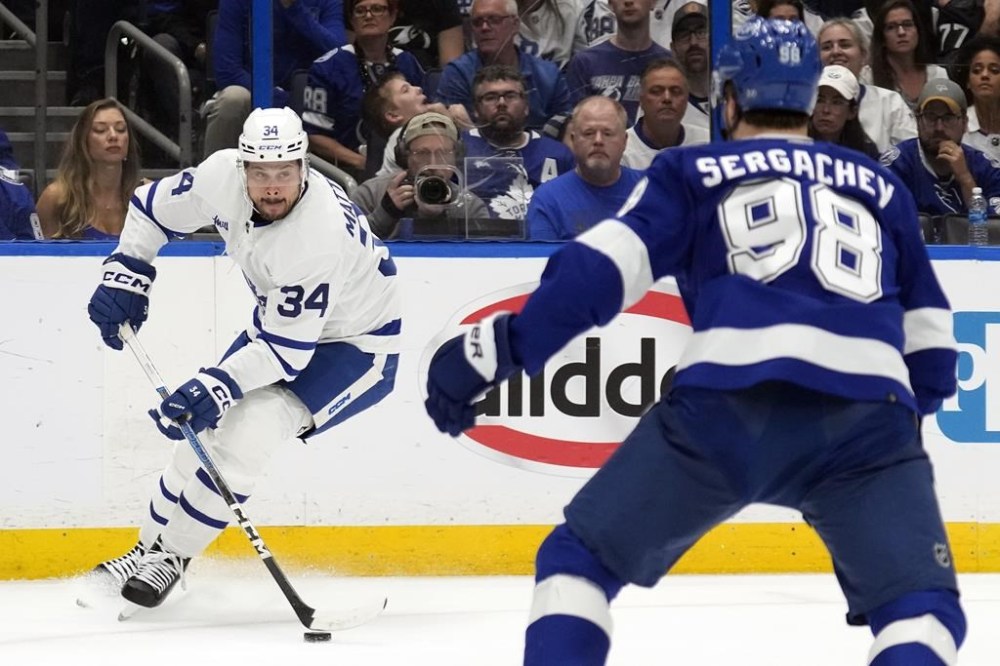 Toronto Maple Leafs center Auston Matthews (34) stops short in front of Tampa Bay Lightning defenseman Mikhail Sergachev (98) during the first period in Game 6 of an NHL hockey Stanley Cup first-round playoff series Saturday, April 29, 2023, in Tampa, Fla. (AP Photo/Chris O'Meara)