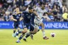 CF Montreal forward Chinonso Offor, right, runs past Sporting Kansas City defender Robert Castellanos, left, during the second half of an MLS soccer match aturday, April 29, 2023, in Kansas City, Kan. (AP Photo/Nick Tre. Smith)