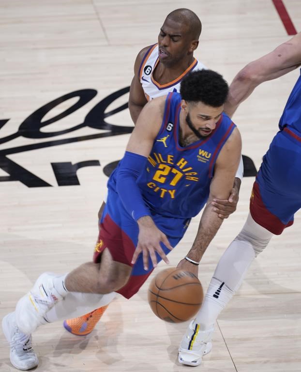 Denver Nuggets guard Jamal Murray drives against Phoenix Suns guard Chris Paul during the first half of Game 1 of an NBA second-round basketball series Saturday, April 29, 2023, in Denver. (AP Photo/David Zalubowski)