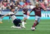 Vancouver Whitecaps' Tristan Blackmon, left, dives to take the ball away from Colorado Rapids' Michael Barrios during the first half of an MLS soccer game in Vancouver, on Saturday, April 29, 2023. THE CANADIAN PRESS/Darryl Dyck
