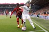 Bournemouth's Dango Ouattara, left, and Leeds United's Jack Harrison battle for the ball during the English Premier League soccer match between Bournemouth and Leeds United at the Vitality Stadium, Bournemouth, England, Sunday April 30, 2023. (Steven Paston/PA via AP)