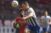Berlin's Filip Uremovic, top, and Bayern's Kingsley Coman challenge for the ball during the German Bundesliga soccer match between FC Bayern Munich and Hertha BSC Berlin at the Allianz Arena stadium in Munich, Germany, April 30, 2023. (AP Photo/Matthias Schrader)