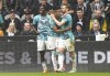 Southampton's Stuart Armstrong, right, celebrates scoring their side's first goal of the game with teammates during the English Premier League soccer match between Newcastle United and Southampton at St James' Park, Newcastle upon Tyne, England, Sunday, April 30, 2023. (Owen Humphreys/PA via AP)