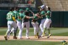 Oakland Athletics' Esteury Ruiz, third from right, celebrates with teammates after hitting the winning RBI-single against the Cincinnati Reds during the ninth inning of a baseball game in Oakland, Calif., Sunday, April 30, 2023. (AP Photo/Godofredo A. Vásquez)