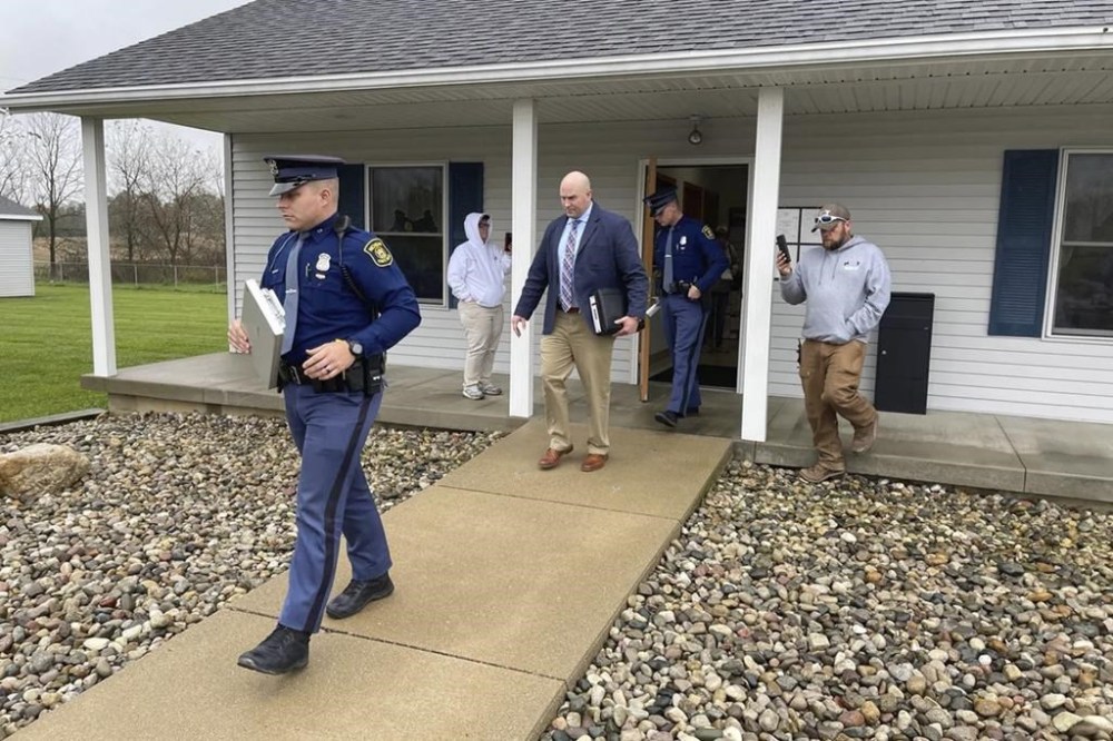 The Michigan State Police exit the Adams Township Hall after executing a search warrant, Oct. 29, 2021 in Hillsdale, Mich. The search warrant was part of an investigation into actions by Clerk Stephanie Scott who has been stripped of her role in future elections. The clerk in one of the Michigan's most conservative counties faces a recall election after the state says she improperly handled voting equipment following false claims about the 2020 election. (Corey Murray/Hillsdale Daily News via AP)