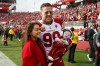 FILE - Arizona Cardinals defensive end J.J. Watt (99) poses with his wife, Kealia, and their son, Koa, before an NFL football game against the San Francisco 49ers in Santa Clara, Calif., Sunday, Jan. 8, 2023. Former NFL star J.J. Watt and his wife, Kealia, have announced an investment in the English soccer club Burnley, which recently earned promotion to the Premier League. The two announced their investement on Monday, May 1, 2023, with J.J. joking that he's “officially retiring from retirement.” (AP Photo/Jed Jacobsohn, File)