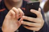 A young person uses a smartphone in Chicago. Canadians may not have it as bad as their neighbours to the south when it comes to the number of spam calls they receive, but a new study suggests there's been an uptick in phone scams preying on them, such as those involving federal agency impersonation or air duct cleaning. THE CANADIAN PRESS/AP