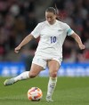 FILE - England's Fran Kirby plays the ball during the women's friendly soccer match between England and the US at Wembley stadium in London, Friday, Oct. 7, 2022. English forward Fran Kirby has announced Tuesday that she will miss this summer’s Women’s World Cup because of a knee injury. Kirby was injured while playing for her club team Chelsea on Feb. 9 during the Continental League Cup semi-final against West Ham. (AP Photo/Kirsty Wigglesworth, File)
