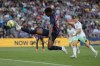 Barcelona's Ansu Fati stretches to reach the ball during a Spanish La Liga soccer match between Barcelona and Osasuna at the Camp Nou stadium in Barcelona, Spain, Tuesday, May 2, 2023. (AP Photo/Joan Monfort)
