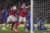Arsenal's Leandro Trossard, centre, celebrates after Arsenal's Gabriel Jesus scored his side's third goal during the English Premier League soccer match between Arsenal and Chelsea at the Emirates Stadium in London, Tuesday, May 2, 2023. (AP Photo/Kin Cheung)