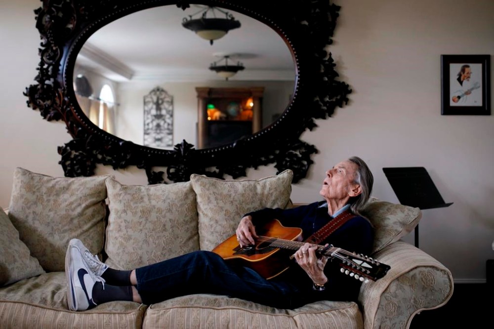 Canadian musician Gordon Lightfoot strums his guitar in his Toronto home on April 25, 2019. Lightfoot died of natural causes on Monday at age 84. THE CANADIAN PRESS/Cole Burston