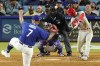 Philadelphia Phillies' Trea Turner, right, hits a solo home run as Los Angeles Dodgers starting pitcher Julio Urias, left, watches along with catcher Austin Barnes, second from left, and home plate umpire Jeremy Riggs during the fourth inning of a baseball game Tuesday, May 2, 2023, in Los Angeles. (AP Photo/Mark J. Terrill)