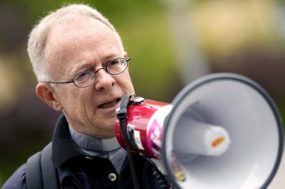 Priest Joerg Alt addresses supporters prior the beginning of his trial at a court in Munich, Germany, Wednesday, May 3, 2023. Alt is accused of blocking a road in Munich last October together with other activists of of Scientist Rebellion protesting for climate protection. (AP Photo/Matthias Schrader)