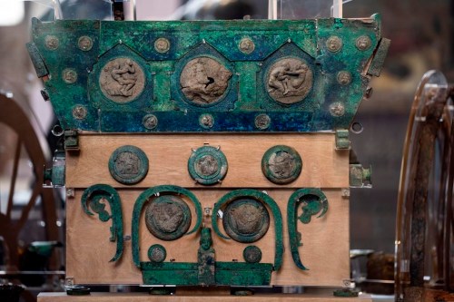 A reconstructed Pompeii bridal chariot, found in 2021 under 4 meters (15 feet) of volcanic ash is on display at the exhibition 'Between us and the ancients. The instant and eternity' in Rome's Diocletian Baths, Wednesday, May 3, 2023. The four-wheeled chariot features silver and bronze decorations, including of erotic scenes. The exhibition will open to the public from May 4 through July 30, 2023. (AP Photo/Domenico Stinellis)