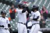 Detroit Tigers designated hitter Eric Haase, right, is greeted by Riley Greene and Javier Baez, left, after his three-run home run during the first inning in the first game of a baseball doubleheader against the New York Mets, Wednesday, May 3, 2023, in Detroit. (AP Photo/Carlos Osorio)