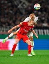 Stuttgart's Wataru Endo, rear, and Frankfurt's Sebastian Rode battle for the ball during the German Soccer Cup semifinal match between VfB Stuttgart and Eintracht Frankfurt at Mercedes-Benz Arena, Stuttgart, Germany, Wednesday May 3, 2023. (Tom Weller/dpa via AP)