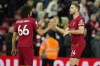 Liverpool's Trent Alexander-Arnold, left, shakes hand with his teammate Jordan Henderson at the end of the English Premier League soccer match between Liverpool and Fulham, at Anfield Stadium, Liverpool, England, Wednesday, May 3, 2023. (AP Photo/Jon Super)