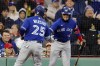 Toronto Blue Jays' Daulton Varsho (25) celebrates his solo home run with Whit Merrifield during the second inning of a baseball game against the Boston Red Sox, Wednesday, May 3, 2023, in Boston. (AP Photo/Michael Dwyer)