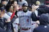Minnesota Twins' Carlos Correa celebrates in the dugout after scoring on Byron Buxton's double off Chicago White Sox starting pitcher Dylan Cease during the third inning of a baseball game on Wednesday, May 3, 2023, in Chicago. (AP Photo/Charles Rex Arbogast)