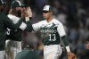 Colorado Rockies second baseman Alan Trejo is congratulated by teammates after the ninth inning of a baseball game against the Milwaukee Brewers, Wednesday, May 3, 2023, in Denver. (AP Photo/David Zalubowski)