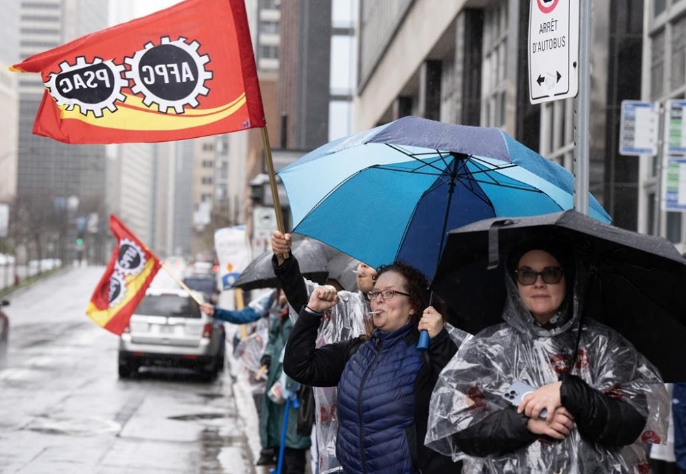 Public Service Alliance of Canada (PSAC) workers at the Canada Revenue Agency (CRA) strike in Montreal, Monday, May 1, 2023. The public-sector union representing Canada Revenue Agency employees has struck a tentative deal with the federal government, ending a strike of 35,000 workers just after the tax season wrapped up. THE CANADIAN PRESS/Christinne Muschi