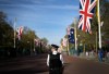A British police officer stands guard as people line up days before the official coronation of King Charles III near Buckingham Palace along the Mall in London on Wednesday, May 3, 2023. THE CANADIAN PRESS/Nathan Denette