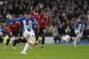 Brighton's Alexis Mac Allister shoots to score from the penalty spot during the English Premier League soccer match between Brighton and Hove Albion and Manchester United at the AMEX stadium in Brighton, England, Thursday, May 4, 2023. (AP Photo/Kirsty Wigglesworth)