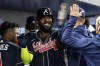 Atlanta Braves Marcell Ozuna (20) is congratulates by his teammates after scoring in the second inning of a baseball game against the Miami Marlins, Thursday, May 4, 2023, in Miami. (AP Photo/Marta Lavandier)