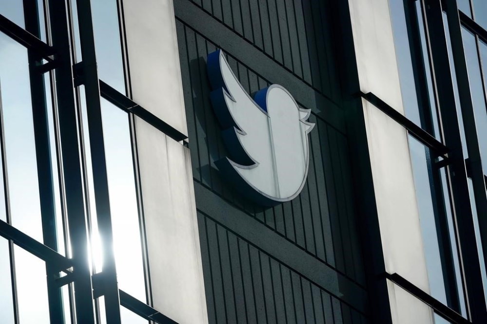 FILE - A Twitter logo hangs outside the company's offices in San Francisco, Dec. 19, 2022. Service alerts for subways, commuter trains and buses in New York City were back on Twitter, Thursday, May 4, 2023, a week after transit officials balked at paying the platform for access. (AP Photo/Jeff Chiu, File)