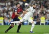 FILE - Osasuna's David Garcia, left, challenges for the ball with Real Madrid's Karim Benzema during the Spanish La Liga soccer match between Real Madrid and Osasuna at the Santiago Bernabeu stadium in Madrid, Spain, Sunday, Oct. 2, 2022. Real Madrid will need to rediscover its winning form come Saturday May 6, 2023 when it faces Osasuna in the Copa del Rey final. Carlo Ancelotti's team has struggled in the Spanish league ahead of the crucial stretch of games starting with the cup final that will determine whether Madrid's season ends in success or failure. (AP Photo/Manu Fernandez, File)