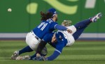 Toronto Blue Jays shortstop Bo Bichette (11) and Toronto Blue Jays centre fielder George Springer (4) collide while to trying to catch a short fly ball during eighth inning American League wild card MLB baseball action against the Seattle Mariners in Toronto on Saturday, October 8, 2022. Blue Jays centre fielder Jackie Bradley Jr. replaced Springer after he was injured on the play. THE CANADIAN PRESS/Frank Gunn