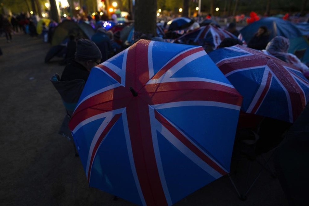 Royal fans spend the night along the King's Coronation route at The Mall in central London, Friday, May 5, 2023. The Coronation of King Charles III will take place at Westminster Abbey on Saturday, May 6, 2023. (AP Photo/Peter Dejong)