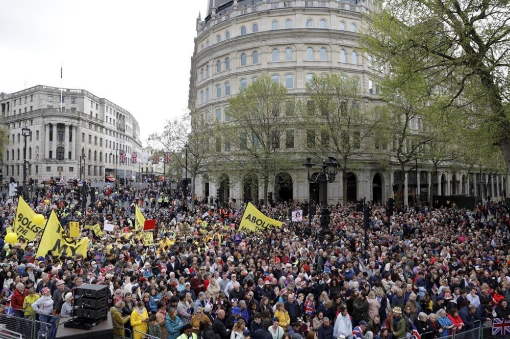 Spectators and anti-royal protesters gather ahead of the coronation of Britain's King Charles III in London Saturday, May 6, 2023. Saturday, May 6, 2023. (Piroschka van de Wouw/Pool via AP)