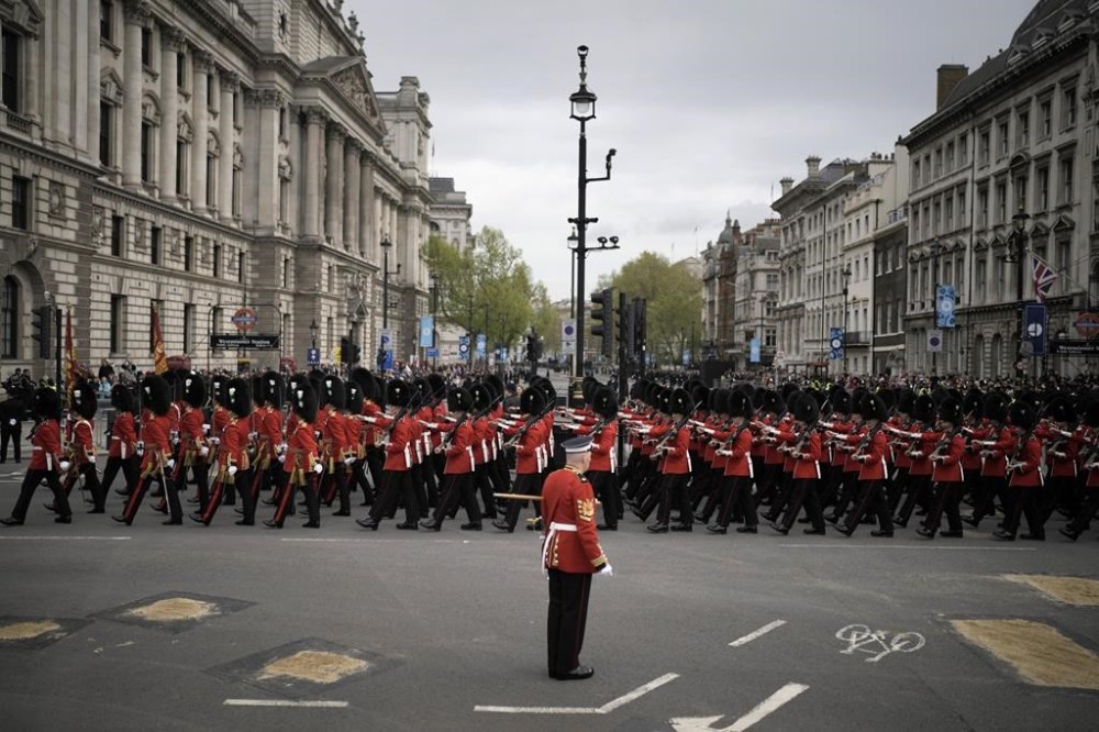 Troops march outside the Palace of Westminster ahead of Britain's King Charles III coronation ceremony in London, Saturday, May 6, 2023. (AP Photo/Markus Schreiber)