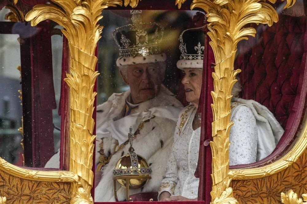 Britain's King Charles III, left, and Queen Camilla depart Westminster Abbey after the coronation ceremony of Britain's King Charles III in London Saturday, May 6, 2023. (AP Photo/Alessandra Tarantino)
