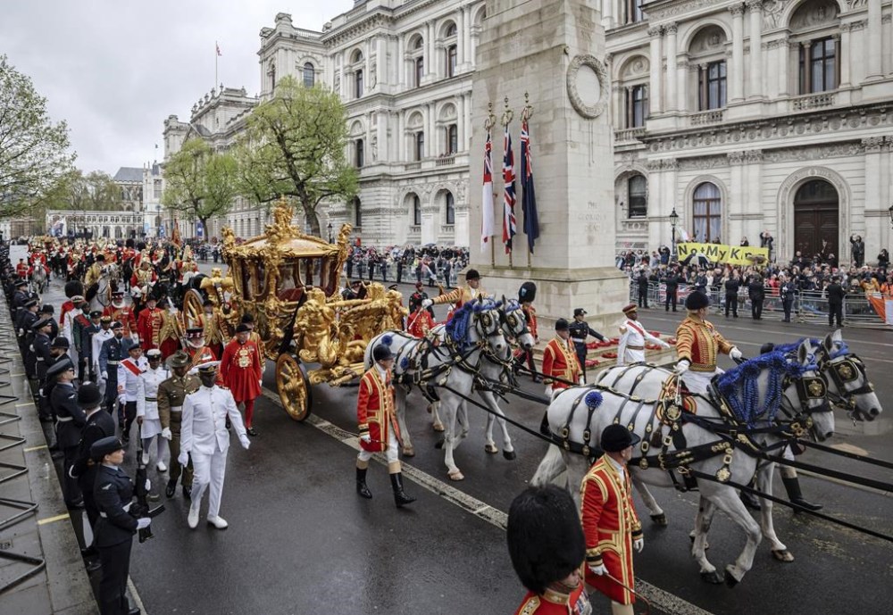Britain's King Charles III and Queen Camilla travel to Buckingham Palace in the Gold State Coach after their coronation ceremony in Westminster Abbey, London, Saturday, May 6, 2023. (Rob Pinney/Pool Photo via AP)