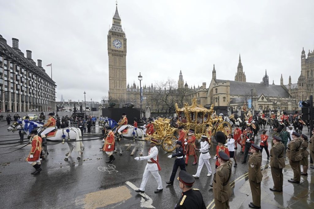 Britain's King Charles III and Queen Camilla ride on the Gold State Coach past the Palace of Westminster, on their way back to Buckingham Palace, during their coronation ceremony in London, Saturday, May 6, 2023. (AP Photo/Markus Schreiber)