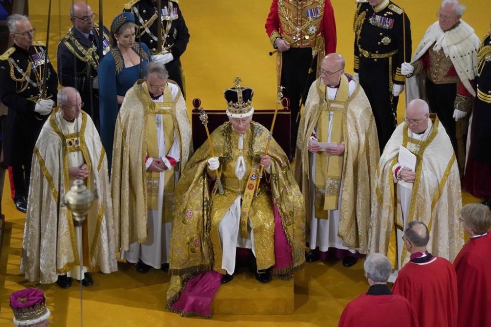 Britain's King Charles III receives The St Edward's Crown during his coronation ceremony at Westminster Abbey, in London, Saturday May 6, 2023. (Andrew Matthews/Pool via AP)